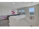 A loft is brightly lit with views from large windows and a gray couch at 2117 Leatherbridge Ct, North Las Vegas, NV 89081