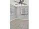 Bedroom featuring tile floors, a ceiling fan, and windows that provide natural light at 230 Mission Newport Ln # 104, Las Vegas, NV 89107