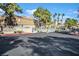 Gated community entrance featuring the Meadows sign surrounded by lush landscaping at 230 Mission Newport Ln # 104, Las Vegas, NV 89107