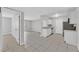 Bright kitchen featuring tile floors, white cabinets, stainless steel appliances, and an open floor plan at 230 Mission Newport Ln # 104, Las Vegas, NV 89107