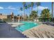 Inviting community pool with lounge chairs, palm trees, and well-maintained landscaping at 230 Mission Newport Ln # 104, Las Vegas, NV 89107