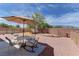 Relaxing backyard featuring a covered patio, gravel landscaping, and privacy fencing at 2304 Willow Wren Dr, North Las Vegas, NV 89084