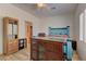 Spacious bedroom with tile floors, ceiling fan, and access to an ensuite bathroom at 2304 Willow Wren Dr, North Las Vegas, NV 89084