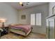 Cozy bedroom with wood-look flooring, a ceiling fan, shutters, and neutral walls at 2304 Willow Wren Dr, North Las Vegas, NV 89084