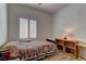 Bedroom showcasing wood-look flooring, and a window with plantation shutters at 2304 Willow Wren Dr, North Las Vegas, NV 89084