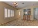 Bright dining room featuring wood-look tile flooring and access to the kitchen with breakfast bar at 2304 Willow Wren Dr, North Las Vegas, NV 89084