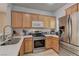 Well-equipped kitchen with stainless steel appliances, light wood cabinets, and a stainless steel sink at 2304 Willow Wren Dr, North Las Vegas, NV 89084