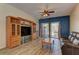 Cozy living room with built-in shelving, wood-look tile, and a sliding door leading to outdoor patio at 2304 Willow Wren Dr, North Las Vegas, NV 89084