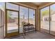 Enclosed patio area featuring concrete flooring, decorative bench, and large sliding doors to the backyard at 2304 Willow Wren Dr, North Las Vegas, NV 89084