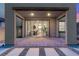 Covered back patio featuring stylish pavers and seamless access to the home's interior through sliding glass doors at 2367 Ridgeline Wash St, Las Vegas, NV 89138