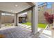 Inviting backyard with a covered patio, lush lawn, and stylish pavers, creating a perfect outdoor living space at 2367 Ridgeline Wash St, Las Vegas, NV 89138
