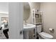 Stylish half-bathroom with a pedestal sink, modern fixtures, and a view into other rooms at 2367 Ridgeline Wash St, Las Vegas, NV 89138