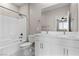 An all-white bathroom featuring double sinks, a toilet, and a shower-tub combo at 2367 Ridgeline Wash St, Las Vegas, NV 89138