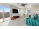 Bright bonus room with balcony, plush carpet, and stylish teal couch provides a comfortable place to relax at 2367 Ridgeline Wash St, Las Vegas, NV 89138