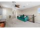 Cozy bonus room features a green sofa, natural light, and a ceiling fan for added comfort at 2367 Ridgeline Wash St, Las Vegas, NV 89138
