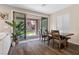 Cozy dining area with wood-look floors, a dining table, and sliding glass doors to the outdoor patio at 2367 Ridgeline Wash St, Las Vegas, NV 89138