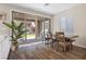 Cozy dining area with wood-look floors, a dining table, and sliding glass doors to the outdoor patio at 2367 Ridgeline Wash St, Las Vegas, NV 89138