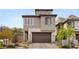 Modern two-story home with a stone facade, attached garage, and well-maintained landscaping, enhancing curb appeal at 2367 Ridgeline Wash St, Las Vegas, NV 89138
