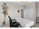 Bright office with a modern white desk, chandelier, and closet access at 2367 Ridgeline Wash St, Las Vegas, NV 89138