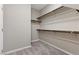 An organized walk-in closet features neutral walls, carpet, and black metal shelving at 2367 Ridgeline Wash St, Las Vegas, NV 89138