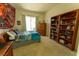 Cozy bedroom featuring a large window, carpeted floor, and built-in bookcase for ample storage space at 2386 Hardin Ridge Dr, Henderson, NV 89052