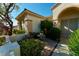 Inviting entrance with a decorative front door, stone accents, and lush landscaping at 2386 Hardin Ridge Dr, Henderson, NV 89052