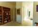 Bright hallway featuring a bookcase and access to the bathroom at 2386 Hardin Ridge Dr, Henderson, NV 89052