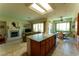 Open-concept kitchen with a central island, tiled floors, and seamless flow into the living area at 2386 Hardin Ridge Dr, Henderson, NV 89052