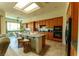 Well-lit kitchen featuring wood cabinetry, stainless steel appliances, and a breakfast bar for casual dining at 2386 Hardin Ridge Dr, Henderson, NV 89052