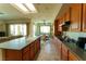 Spacious kitchen with wooden cabinets, tile floors, and stainless steel appliances at 2386 Hardin Ridge Dr, Henderson, NV 89052