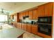 Spacious kitchen showcasing wooden cabinets, modern appliances, and a breakfast nook with outdoor views at 2386 Hardin Ridge Dr, Henderson, NV 89052