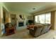 Cozy living room featuring a fireplace, comfortable seating, and bright windows at 2386 Hardin Ridge Dr, Henderson, NV 89052