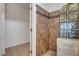 Bathroom with walk-in closet, tile shower, and glass block at 2512 Libretto Ave, Henderson, NV 89052