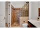 Elegant bathroom featuring tiled shower, glass block, and modern vanity with sink at 2512 Libretto Ave, Henderson, NV 89052