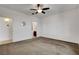 Spacious bedroom with neutral walls, ceiling fan, and views to the en suite bathroom and entry at 2512 Libretto Ave, Henderson, NV 89052