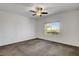 Bright bedroom with carpet, ceiling fan, and a window overlooking greenery at 2512 Libretto Ave, Henderson, NV 89052