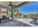 Covered patio with ceiling fan, desert landscaping, and neighborhood views at 2512 Libretto Ave, Henderson, NV 89052