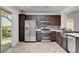 Open concept kitchen with stainless steel appliances, granite countertops, and access to the patio at 2512 Libretto Ave, Henderson, NV 89052
