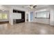Bright living room featuring tile flooring, a ceiling fan, and a built-in shelving unit with bar at 2512 Libretto Ave, Henderson, NV 89052