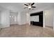 Spacious living room featuring tile flooring, ceiling fan, built-in shelving, and easy access to other rooms at 2512 Libretto Ave, Henderson, NV 89052
