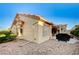 View of the rear exterior of the house with a patio, BBQ, desert landscaping and tan stucco at 2801 Byron Dr, Las Vegas, NV 89134