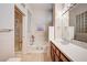Bathroom featuring a glass enclosed shower, soaking tub, and a vanity with white countertop at 2801 Byron Dr, Las Vegas, NV 89134