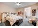 Bright bedroom featuring floral bedding, a ceiling fan, and sitting area at 2801 Byron Dr, Las Vegas, NV 89134