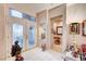 Foyer featuring white tile flooring, decorative glass windows, and art at 2801 Byron Dr, Las Vegas, NV 89134