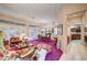 Open-concept living room features purple carpet, shutters, and adjacent dining area and kitchen at 2801 Byron Dr, Las Vegas, NV 89134