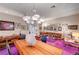 Eclectic living room with bold patterns, purple carpet, and art-filled walls at 2801 Byron Dr, Las Vegas, NV 89134