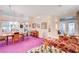 Open-concept living room with purple carpet, chandelier, and decorative furnishings at 2801 Byron Dr, Las Vegas, NV 89134