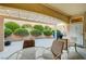 Covered patio featuring desert landscaping, a table and chairs, and a gas grill at 2801 Byron Dr, Las Vegas, NV 89134