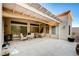 Covered patio with a desert view, ceiling fan, and multiple outdoor seating areas at 2801 Byron Dr, Las Vegas, NV 89134