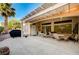 A covered patio featuring multiple seating areas, a ceiling fan, and a desert view at 2801 Byron Dr, Las Vegas, NV 89134